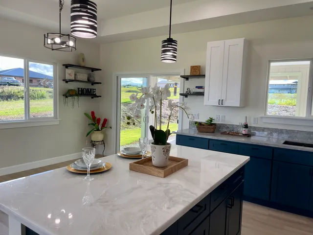 a kitchen with a sink a kitchen island a stove and a cabinets