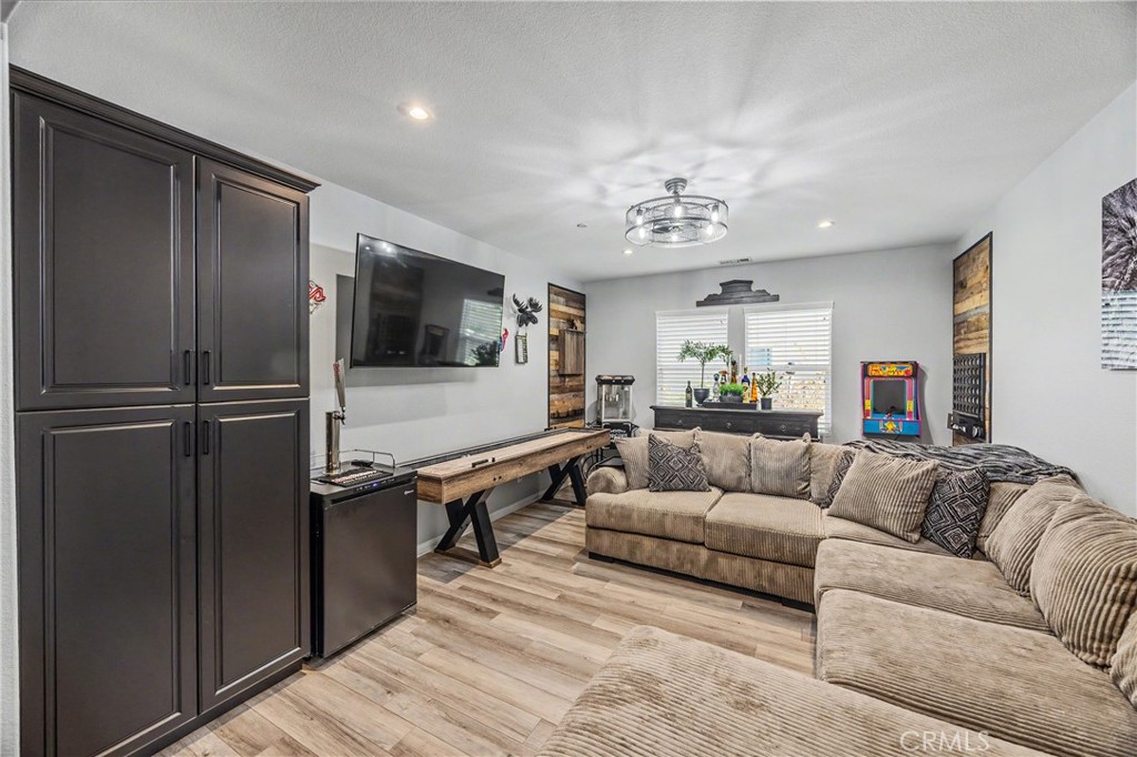 34512 Burnt Pine Road Murrieta, CA 92563 - Photo 8 of 21 a living room with furniture and a flat screen tv