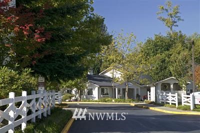 12404 East Gibson Road, Unit N102 Everett, WA 98204 - Photo 1 of 1 a front view of a building with garden