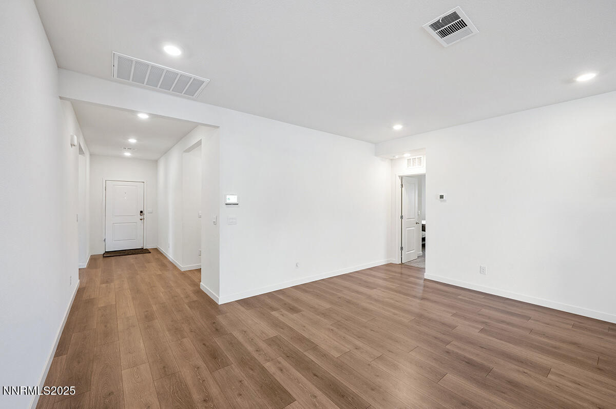720 Butte Crk Road Dayton, NV 89403 - Photo 13 of 25 an empty room with wooden floor and windows