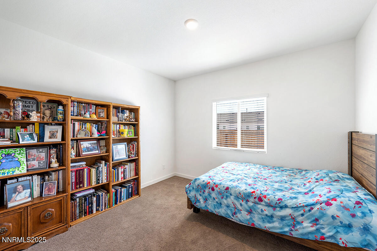 720 Butte Crk Road Dayton, NV 89403 - Photo 17 of 25 a bedroom with a bed and a book shelf