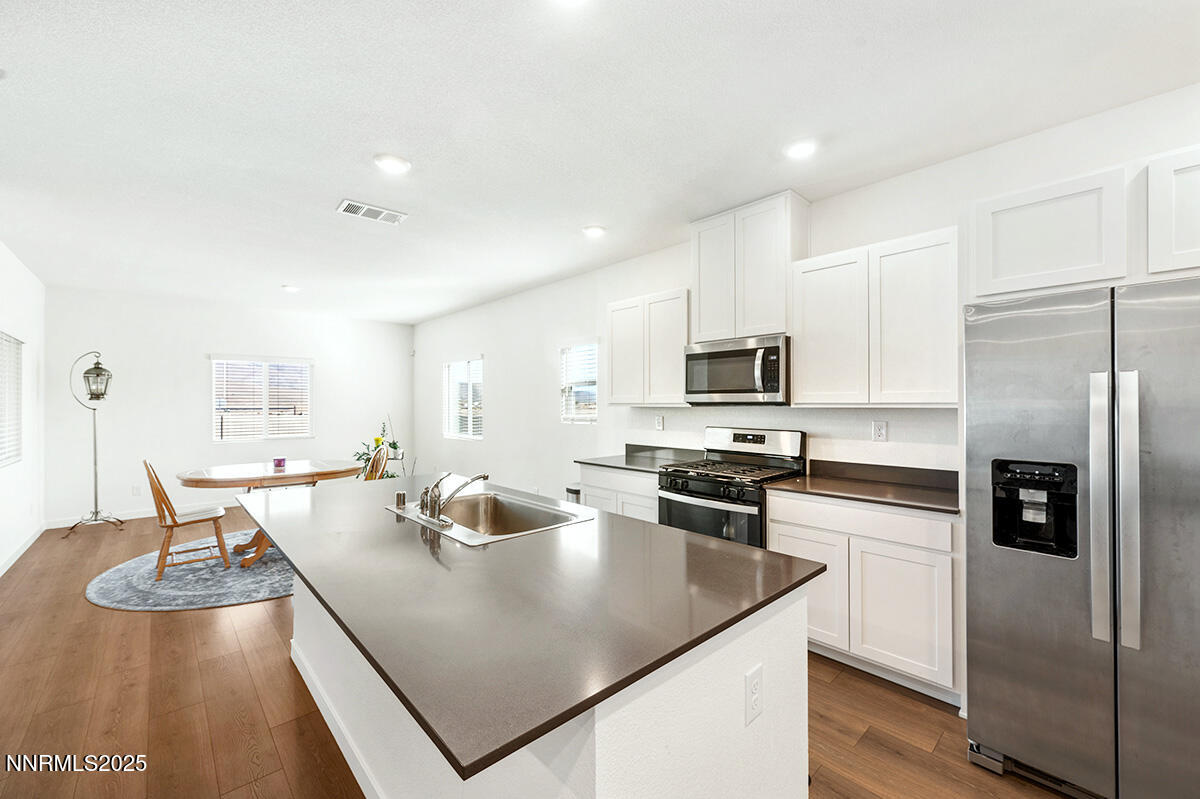 720 Butte Crk Road Dayton, NV 89403 - Photo 9 of 25 a kitchen with stainless steel appliances granite countertop a sink refrigerator and microwave