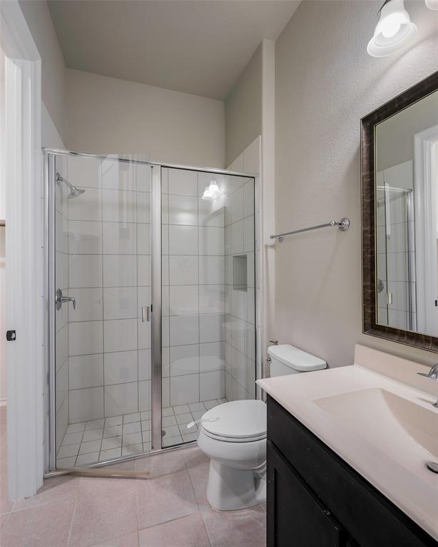941 Leola Lane Allen, TX 75013 - Photo 12 of 37 a bathroom with a shower a toilet and a sink