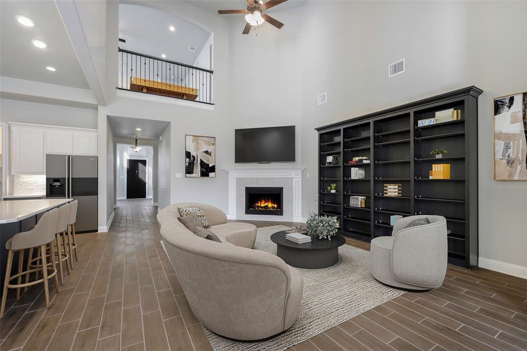 941 Leola Lane Allen, TX 75013 - Photo 13 of 37 a living room with furniture a fireplace and a flat screen tv
