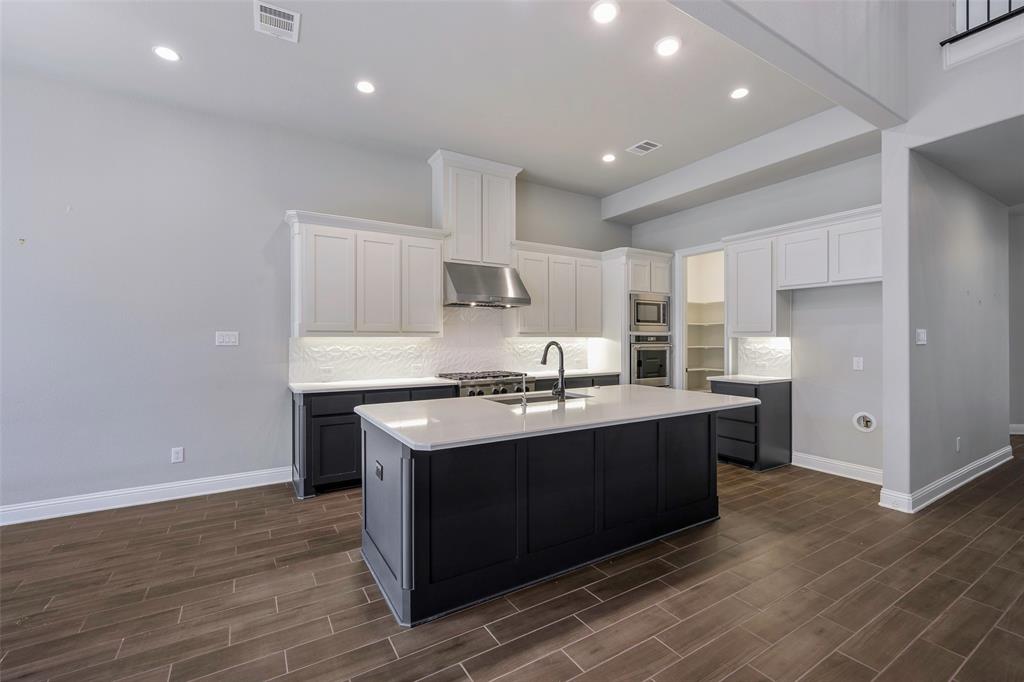 941 Leola Lane Allen, TX 75013 - Photo 16 of 37 a kitchen with stainless steel appliances granite countertop a sink a stove and a refrigerator