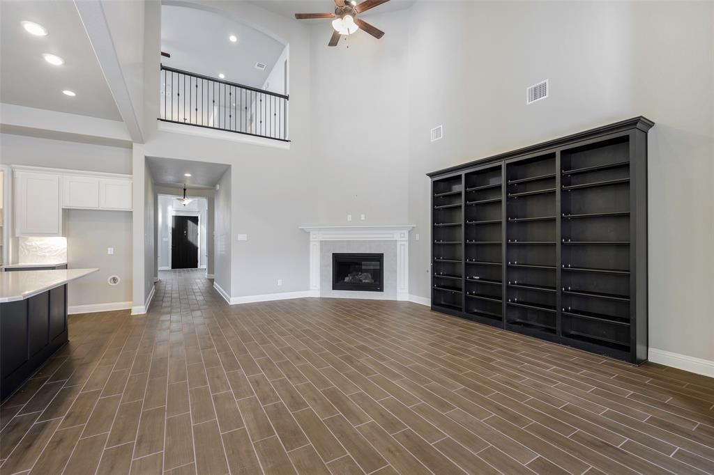 941 Leola Lane Allen, TX 75013 - Photo 17 of 37 wooden floor in an empty room with a fireplace