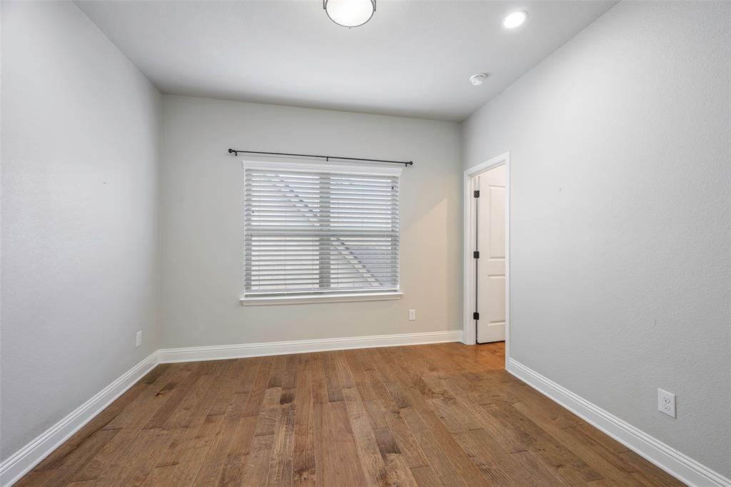 941 Leola Lane Allen, TX 75013 - Photo 28 of 37 an empty room with wooden floor and windows