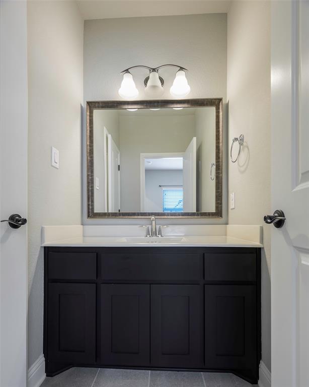 941 Leola Lane Allen, TX 75013 - Photo 29 of 37 a bathroom with a sink vanity and a mirror