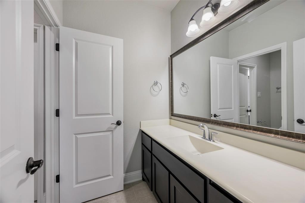 941 Leola Lane Allen, TX 75013 - Photo 30 of 37 a bathroom with a double vanity sink and mirror