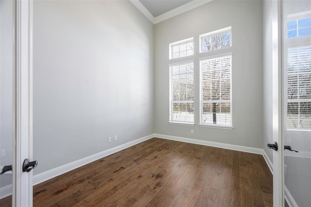 941 Leola Lane Allen, TX 75013 - Photo 4 of 37 an empty room with wooden floor and windows