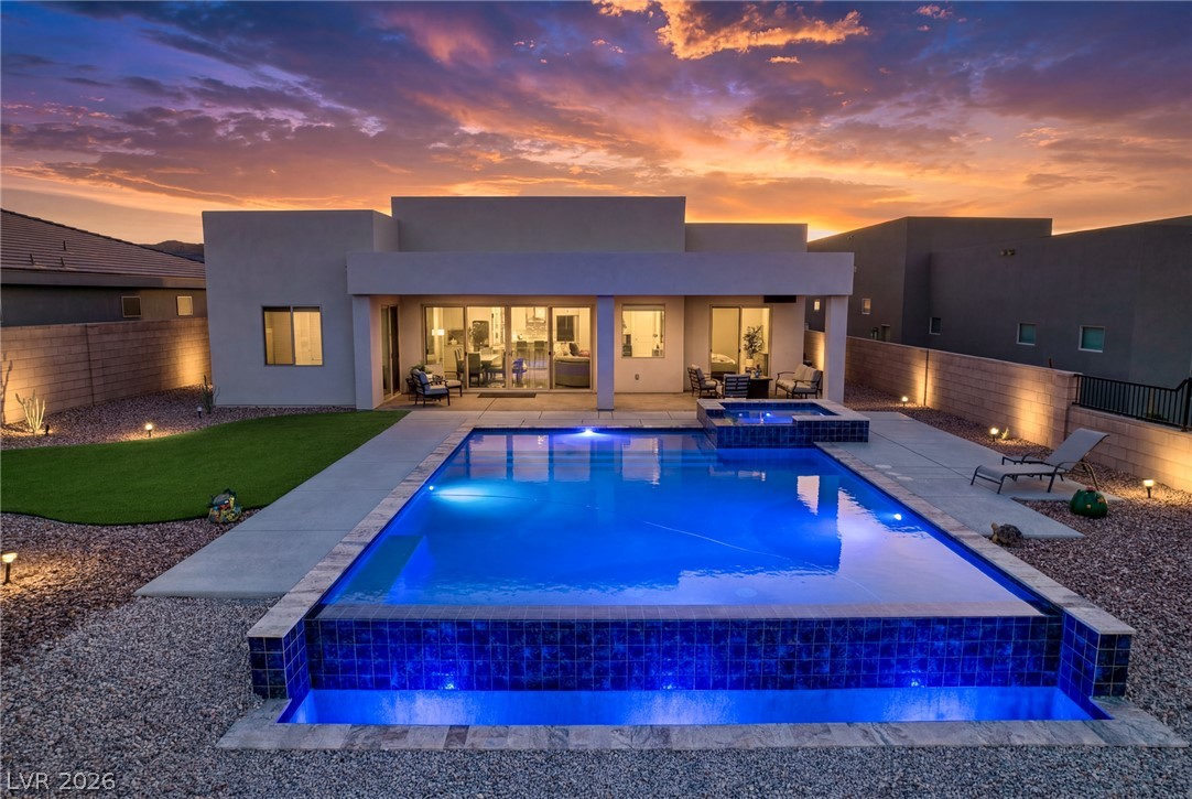 1460 Blue Ridge Trail Mesquite, NV 89027 - Photo 1 of 39 A private desert oasis with a shimmering pool and spa awaits under a fiery sunset.