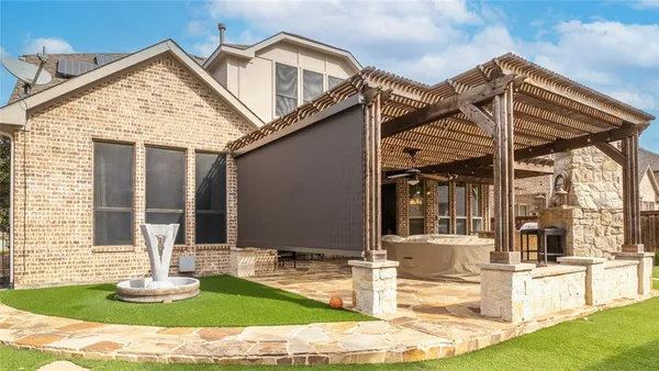 a building outdoor space with patio furniture and potted plants