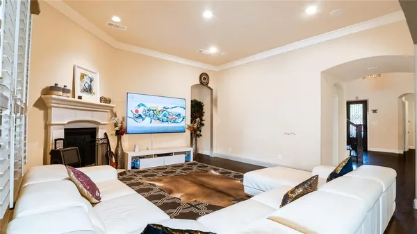 a living room with furniture a flat screen tv and a fireplace