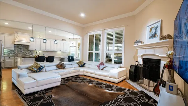 a living room with furniture and a chandelier