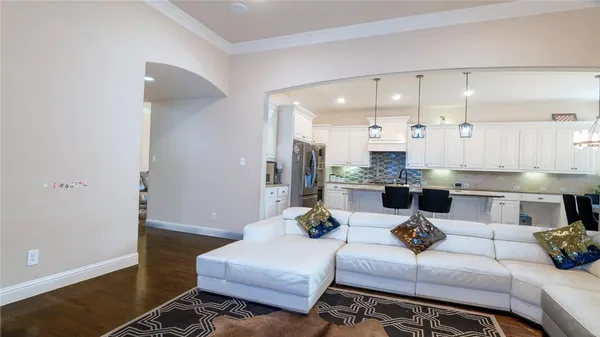 a bedroom with a bed lamp and a large window