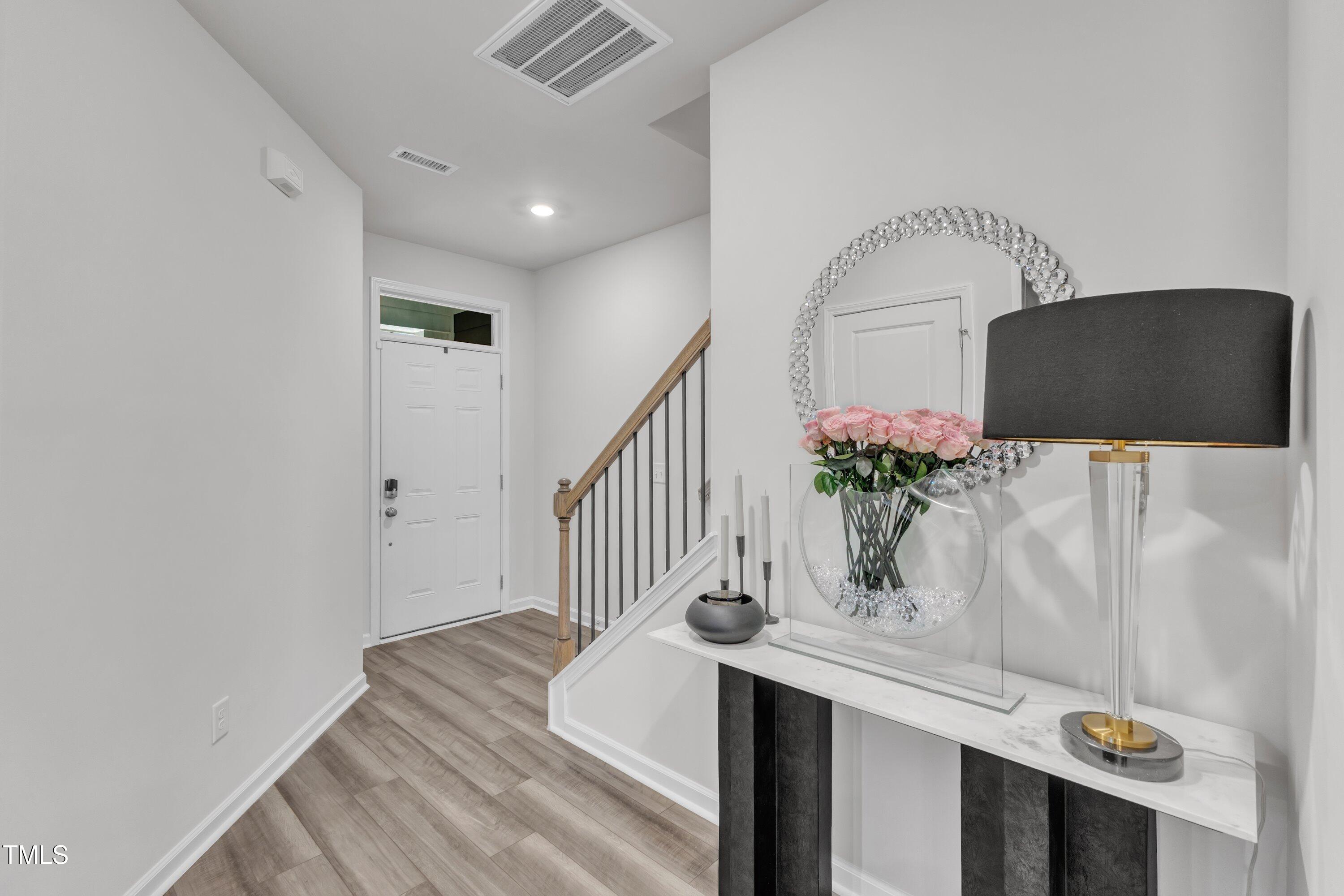 5814 Empathy Lane Raleigh, NC 27616 - Photo 8 of 48 a view of entryway and hall with wooden floor