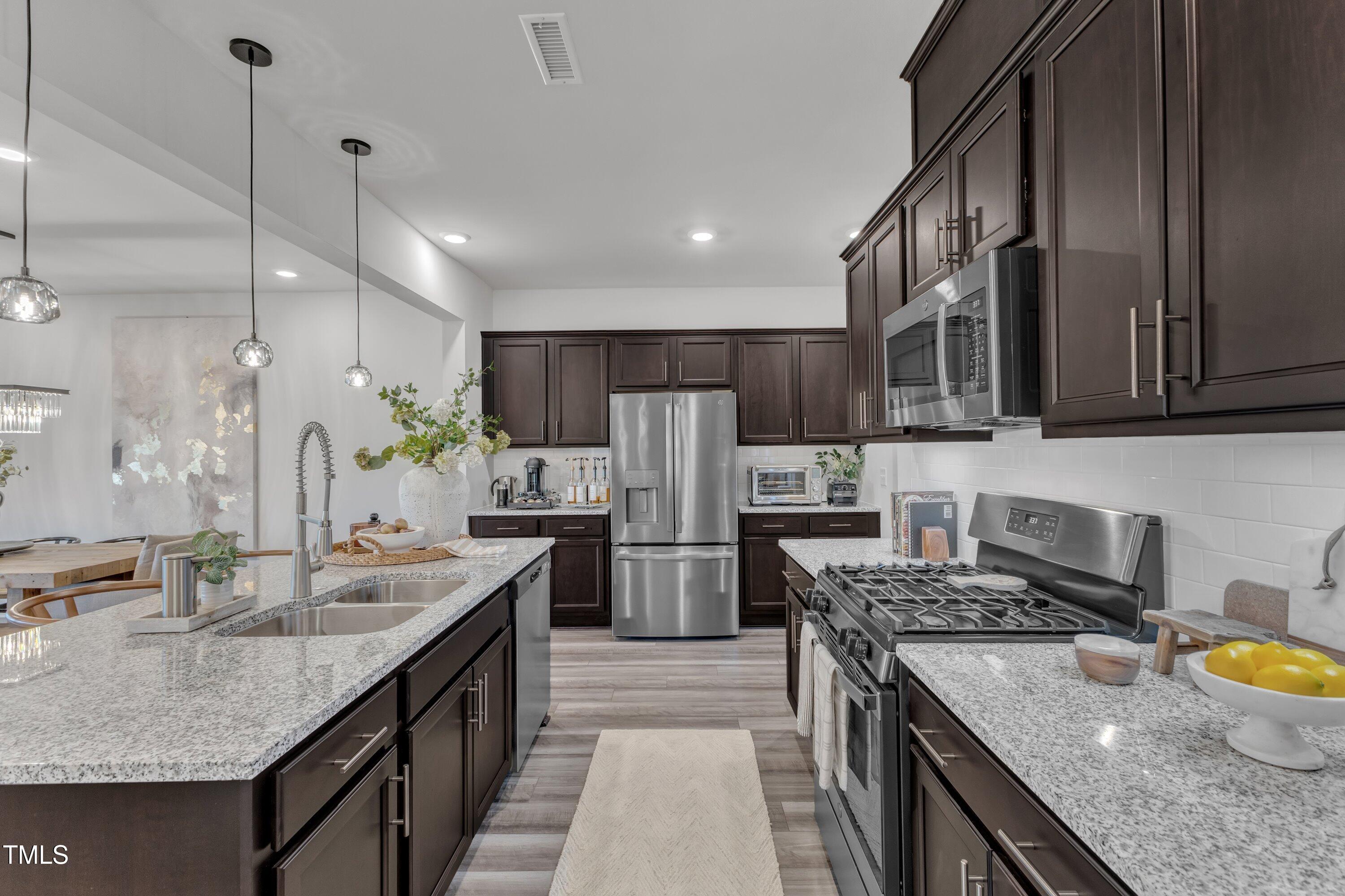 5814 Empathy Lane Raleigh, NC 27616 - Photo 10 of 48 a kitchen with a sink stove and refrigerator