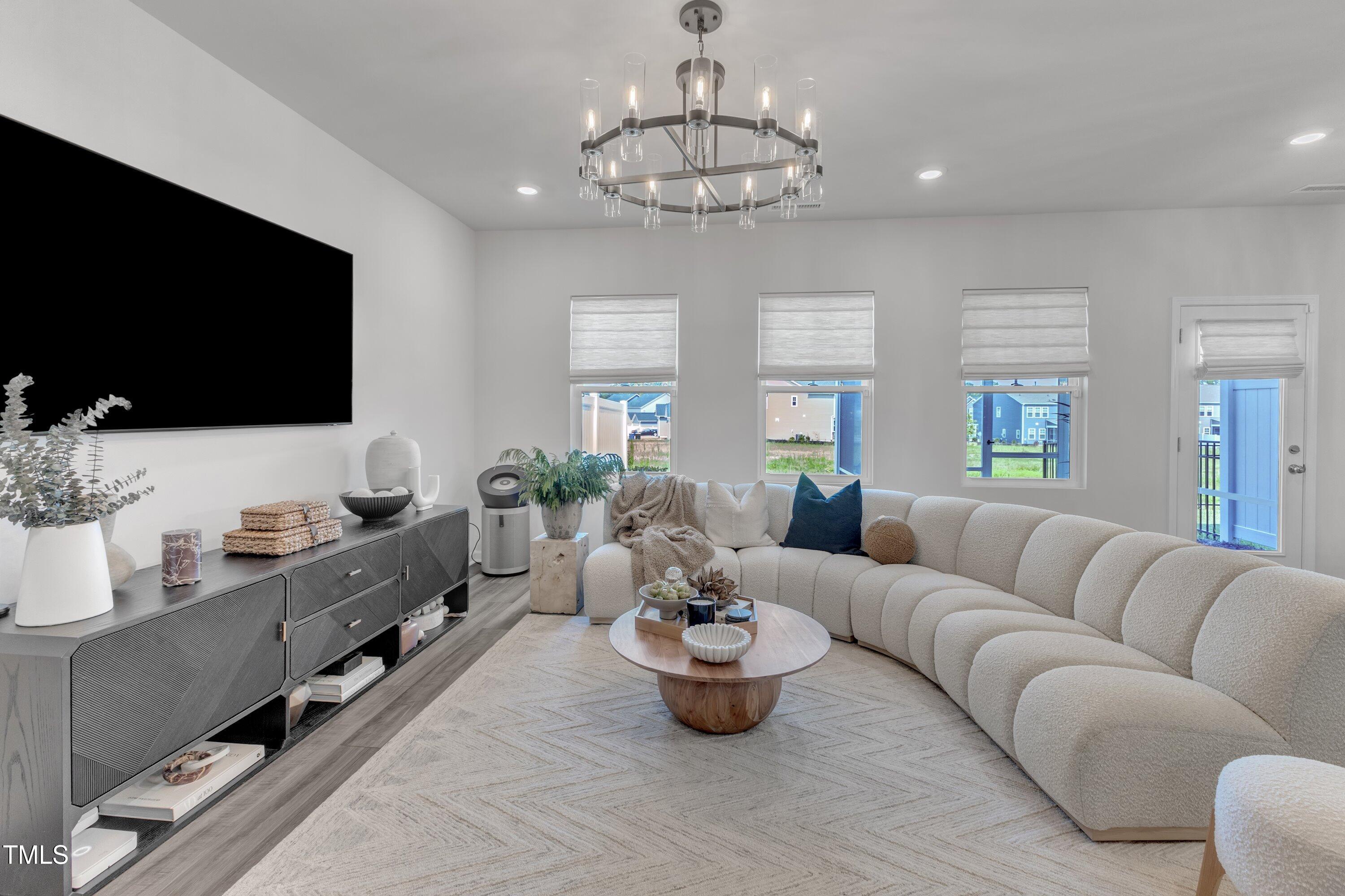 5814 Empathy Lane Raleigh, NC 27616 - Photo 14 of 48 a living room with furniture and a flat screen tv