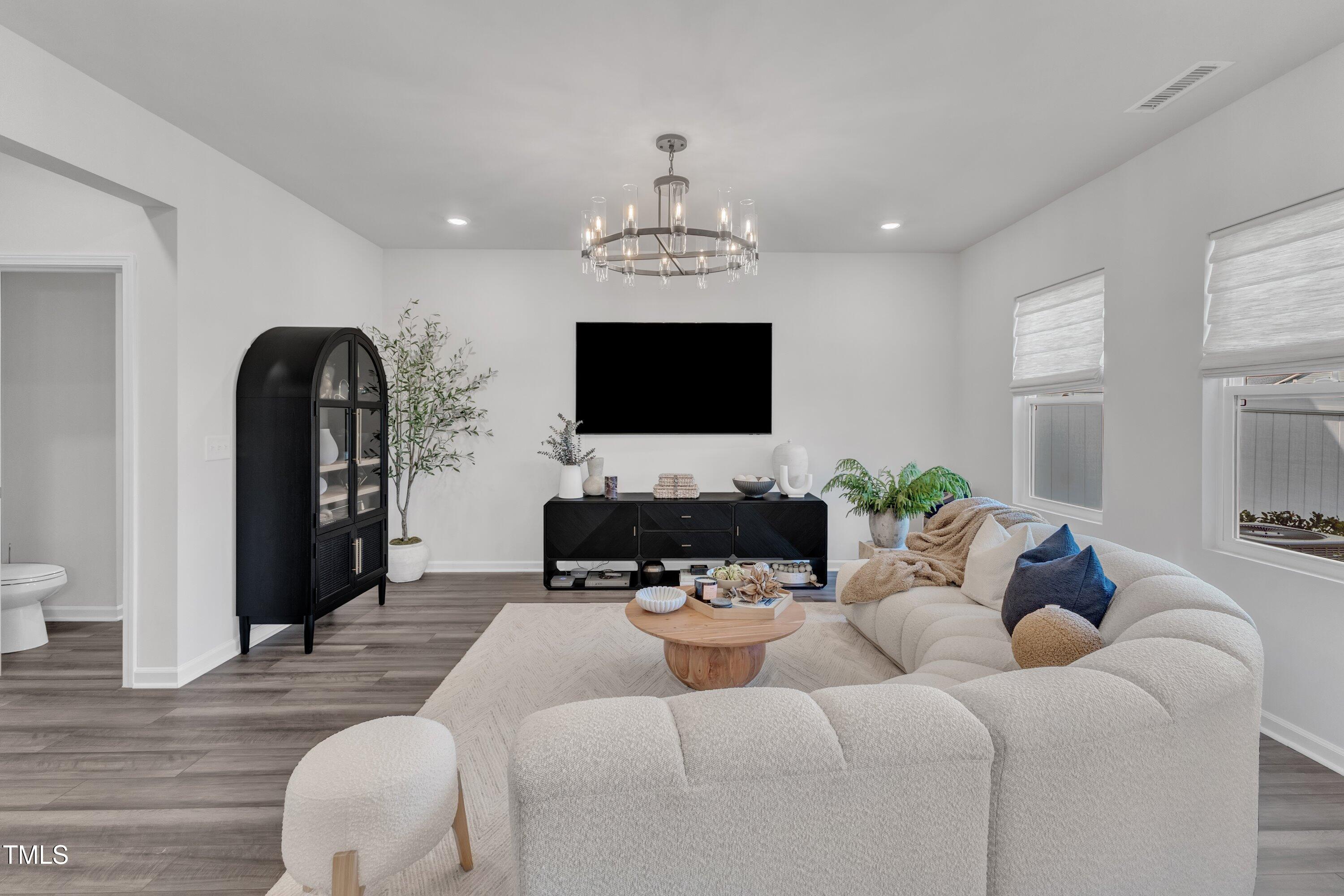 5814 Empathy Lane Raleigh, NC 27616 - Photo 19 of 48 a living room with furniture and a flat screen tv
