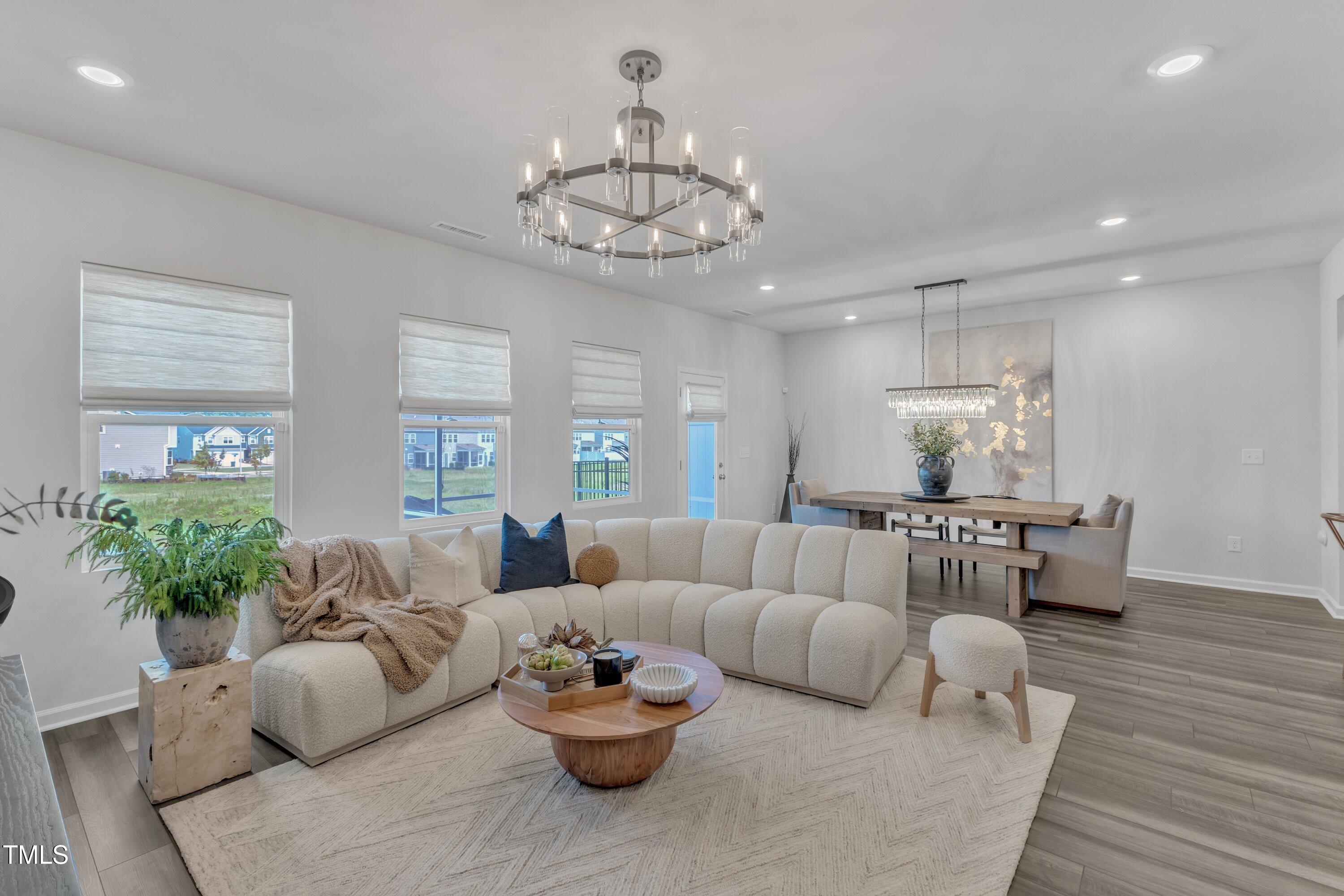 5814 Empathy Lane Raleigh, NC 27616 - Photo 20 of 48 a living room with furniture and a chandelier