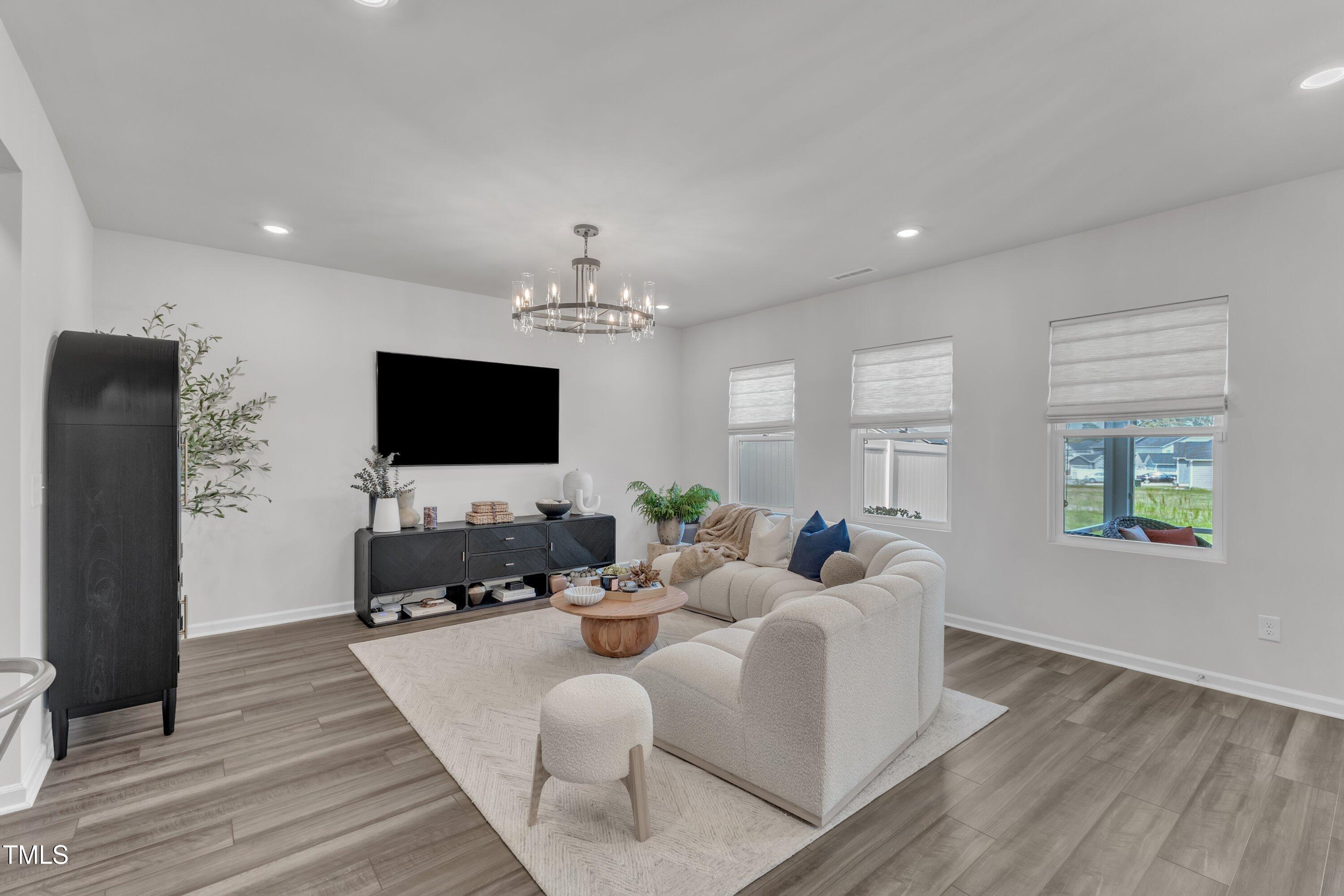 5814 Empathy Lane Raleigh, NC 27616 - Photo 21 of 48 a living room with furniture and a flat screen tv