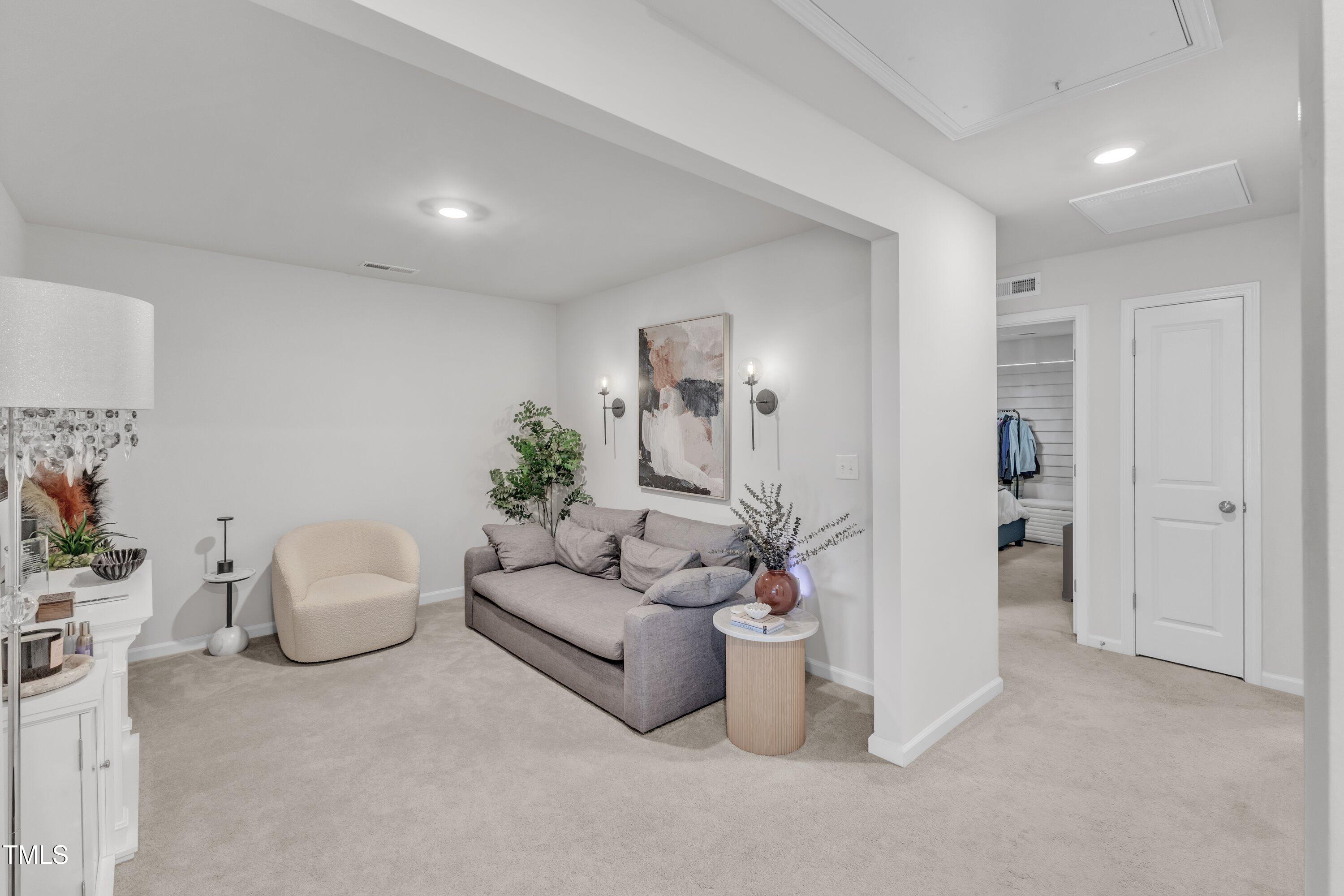 5814 Empathy Lane Raleigh, NC 27616 - Photo 22 of 48 a living room with furniture and flowers