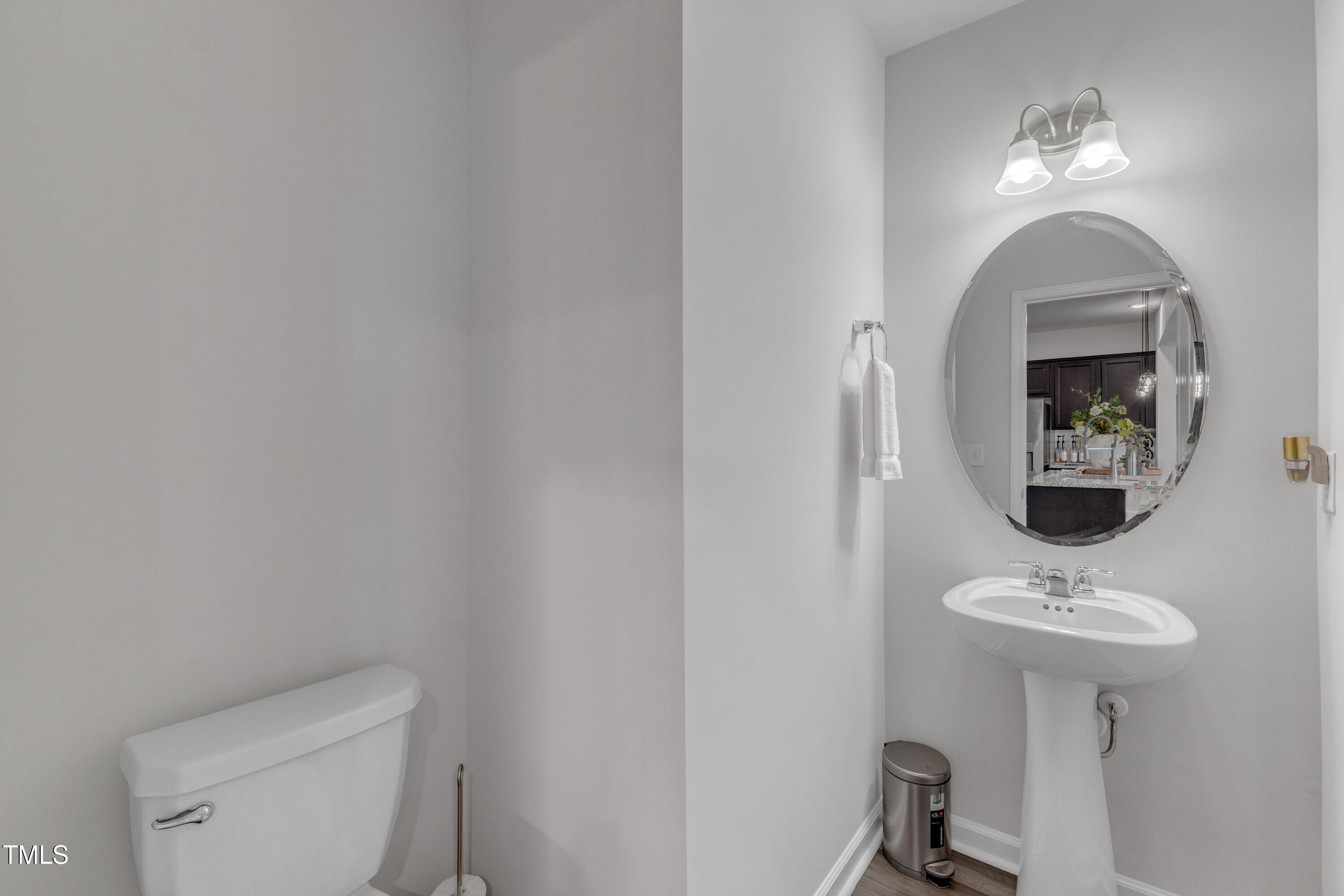 5814 Empathy Lane Raleigh, NC 27616 - Photo 23 of 48 a bathroom with a toilet sink and mirror
