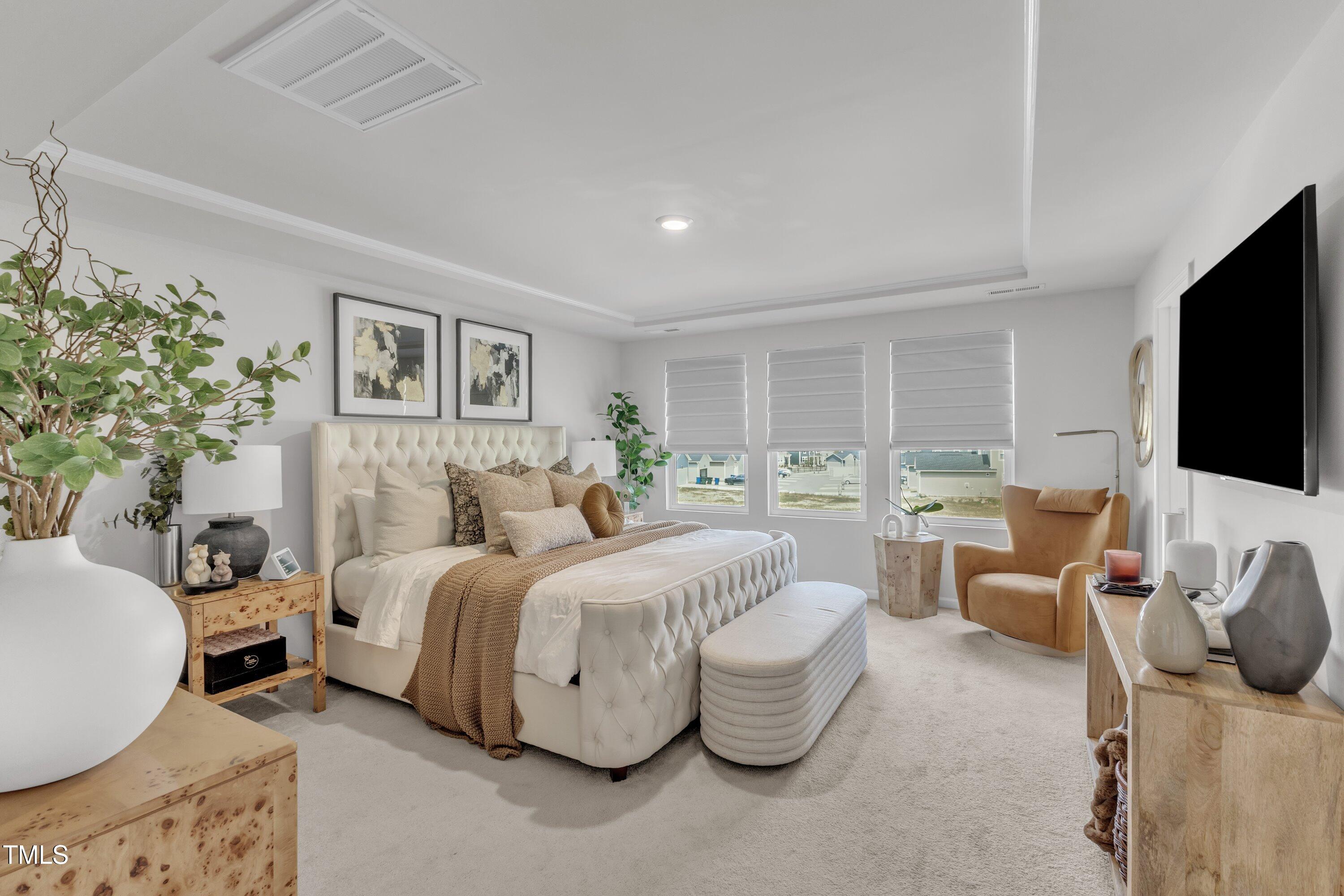 5814 Empathy Lane Raleigh, NC 27616 - Photo 24 of 48 a spacious bedroom with a bed and a flat screen tv