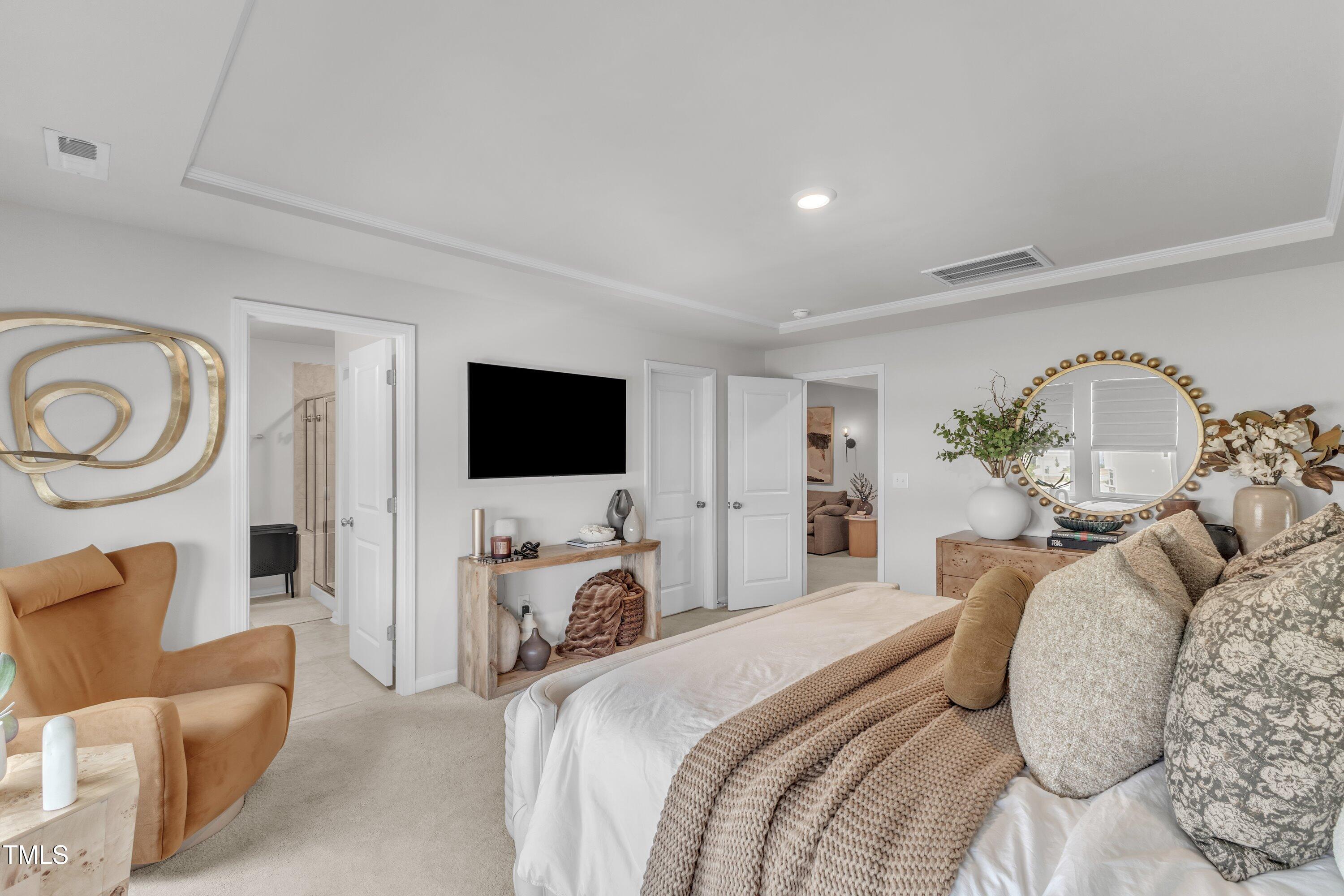 5814 Empathy Lane Raleigh, NC 27616 - Photo 26 of 48 a bedroom with a bed a mirror on dresser and a flat screen tv