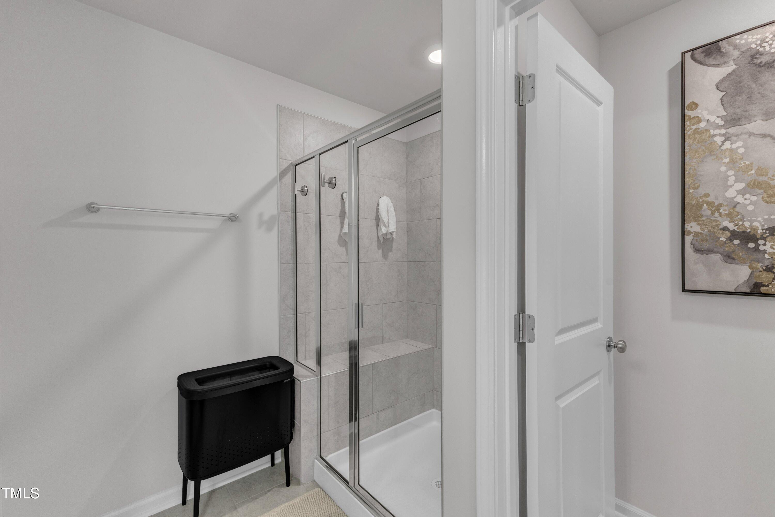 5814 Empathy Lane Raleigh, NC 27616 - Photo 28 of 48 a bathroom with a shower and a chair
