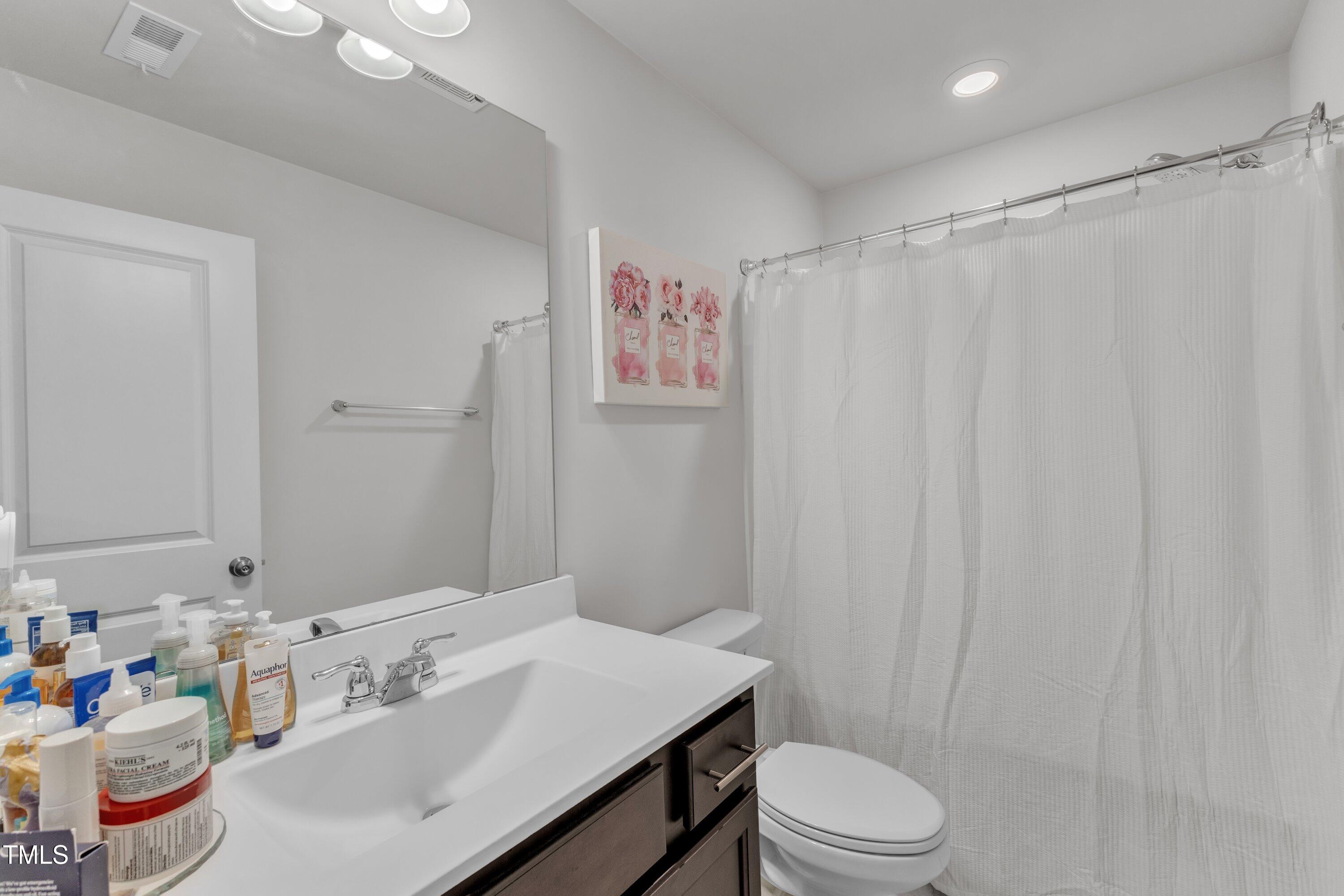5814 Empathy Lane Raleigh, NC 27616 - Photo 29 of 48 a bathroom with a sink toilet and shower