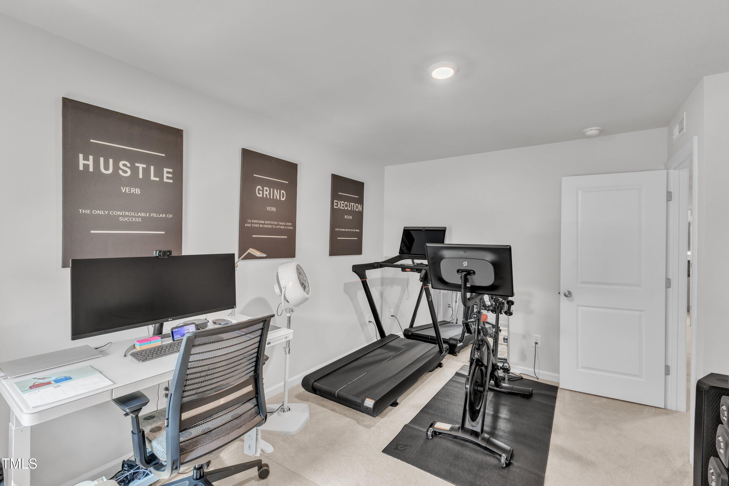 5814 Empathy Lane Raleigh, NC 27616 - Photo 33 of 48 a room with gym equipment and a flat screen tv