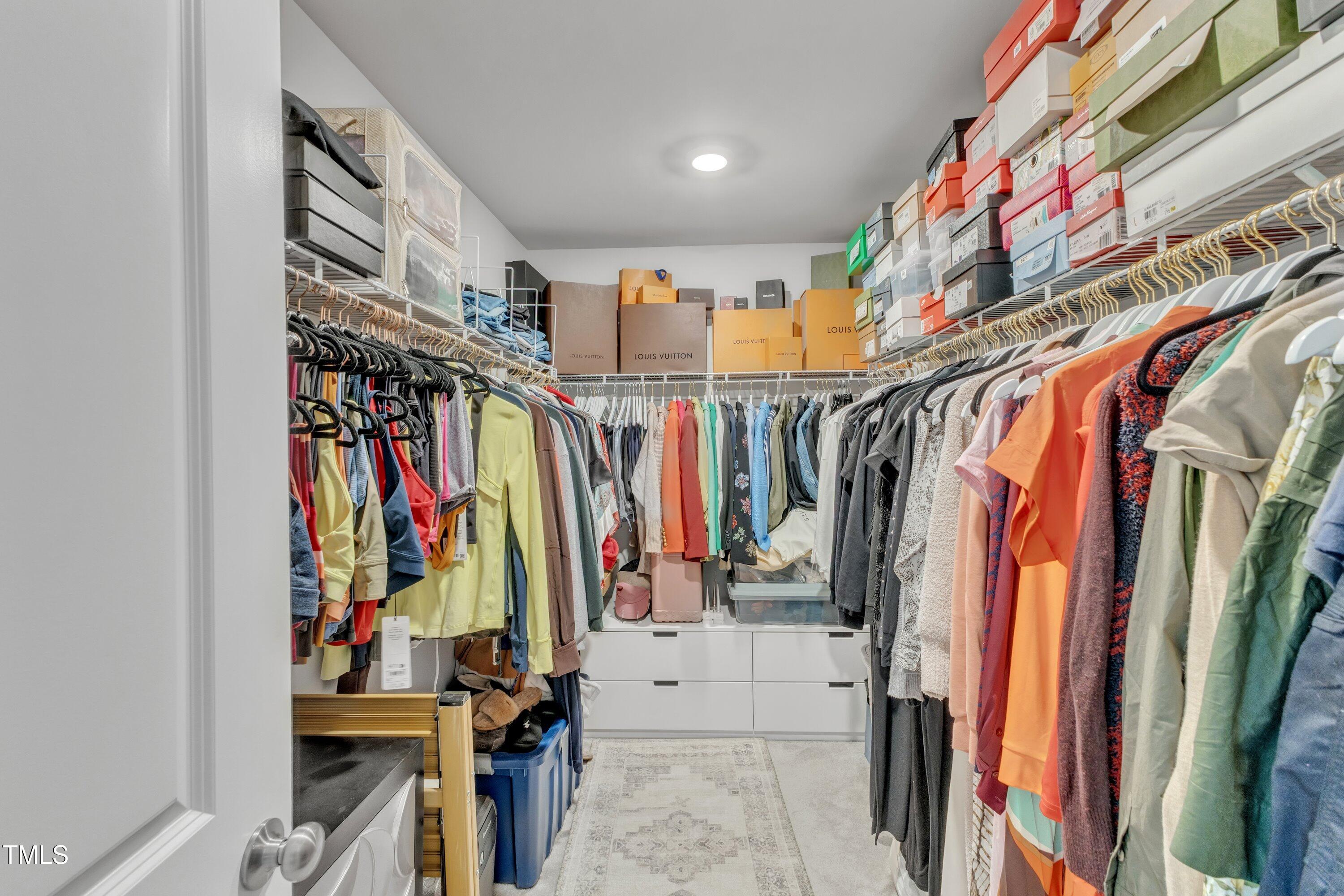 5814 Empathy Lane Raleigh, NC 27616 - Photo 36 of 48 a view of walk in closet with clothes and shoes