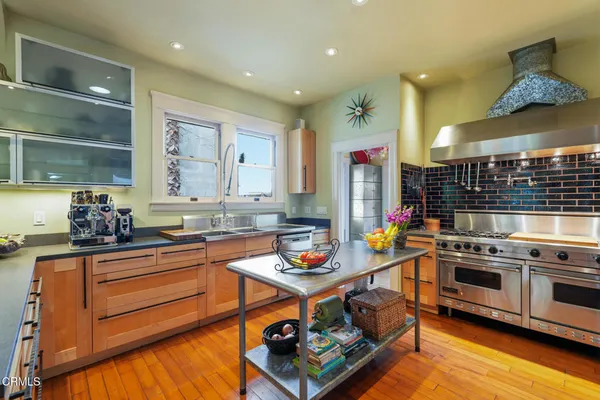 a kitchen with stainless steel appliances granite countertop a stove and cabinets