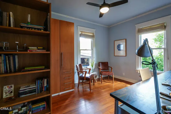 a view of patio with a table and chairs and potted plants