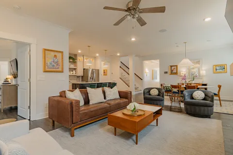 a living room with furniture ceiling fan and a rug