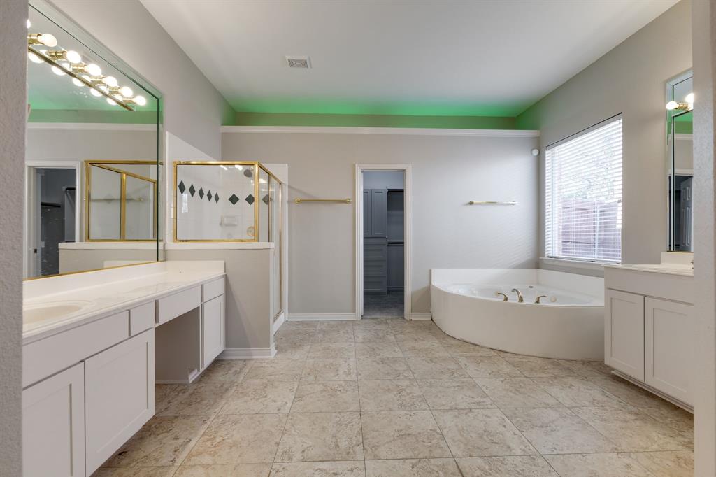 3008 Chippenham Drive Plano, TX 75093 - Photo 13 of 25 a spacious bathroom with a tub sink and mirror