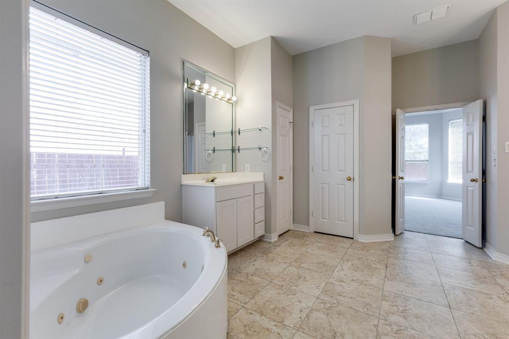 3008 Chippenham Drive Plano, TX 75093 - Photo 14 of 25 a bathroom with a bathtub toilet and sink