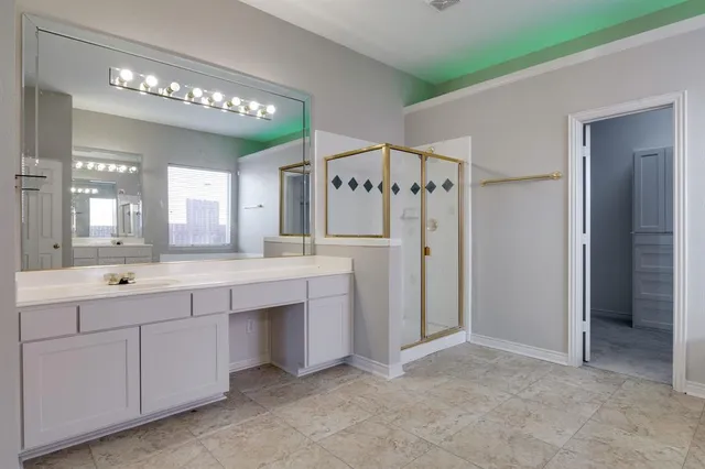 a spacious bathroom with a double vanity sink a mirror and a shower