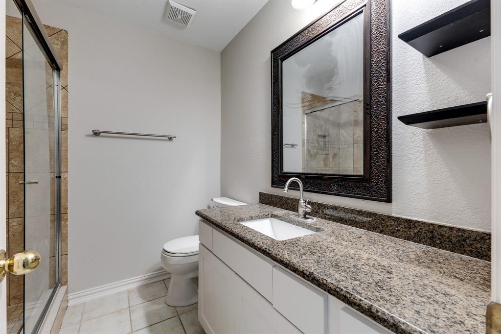 3008 Chippenham Drive Plano, TX 75093 - Photo 17 of 25 a bathroom with a granite countertop sink toilet and mirror