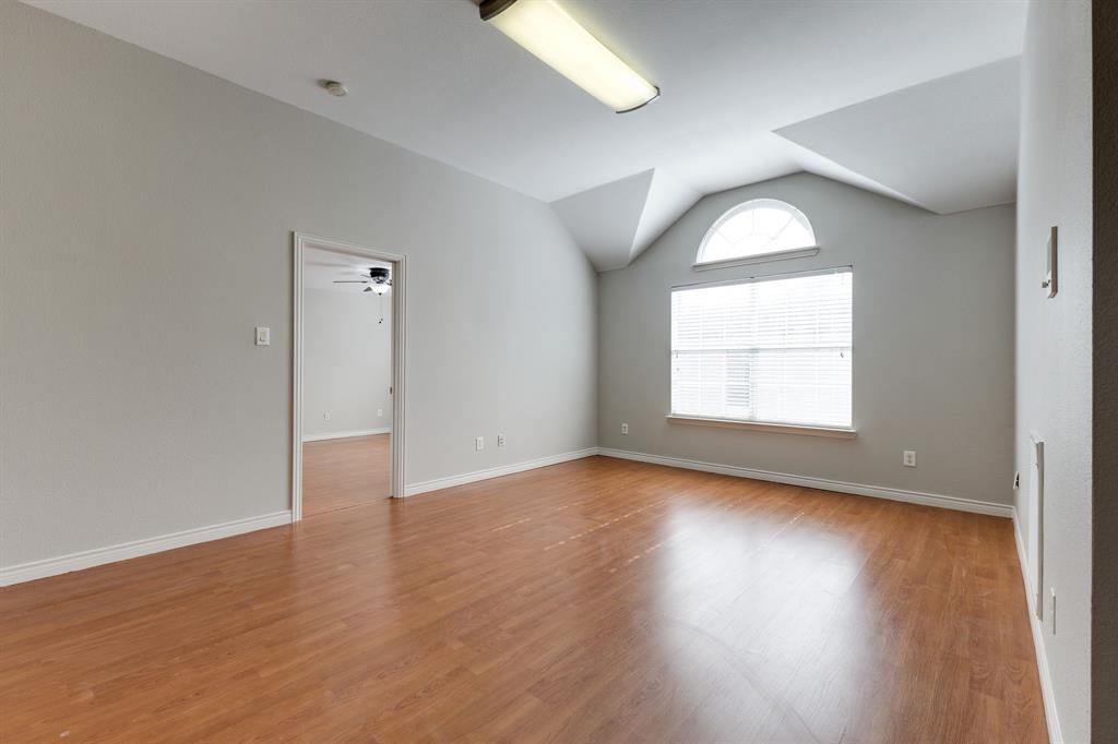 3008 Chippenham Drive Plano, TX 75093 - Photo 18 of 25 an empty room with wooden floor and windows