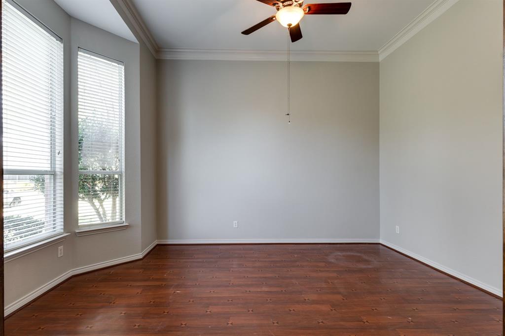 3008 Chippenham Drive Plano, TX 75093 - Photo 2 of 25 an empty room with wooden floor chandelier fan and windows