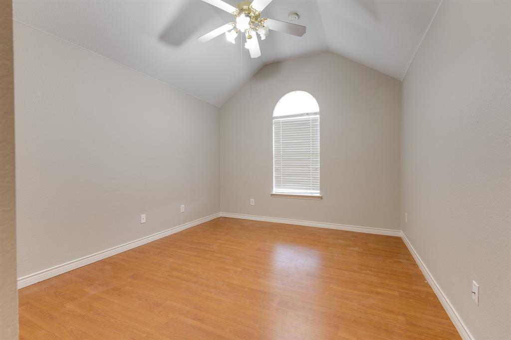 3008 Chippenham Drive Plano, TX 75093 - Photo 22 of 25 an empty room with windows and chandelier fan