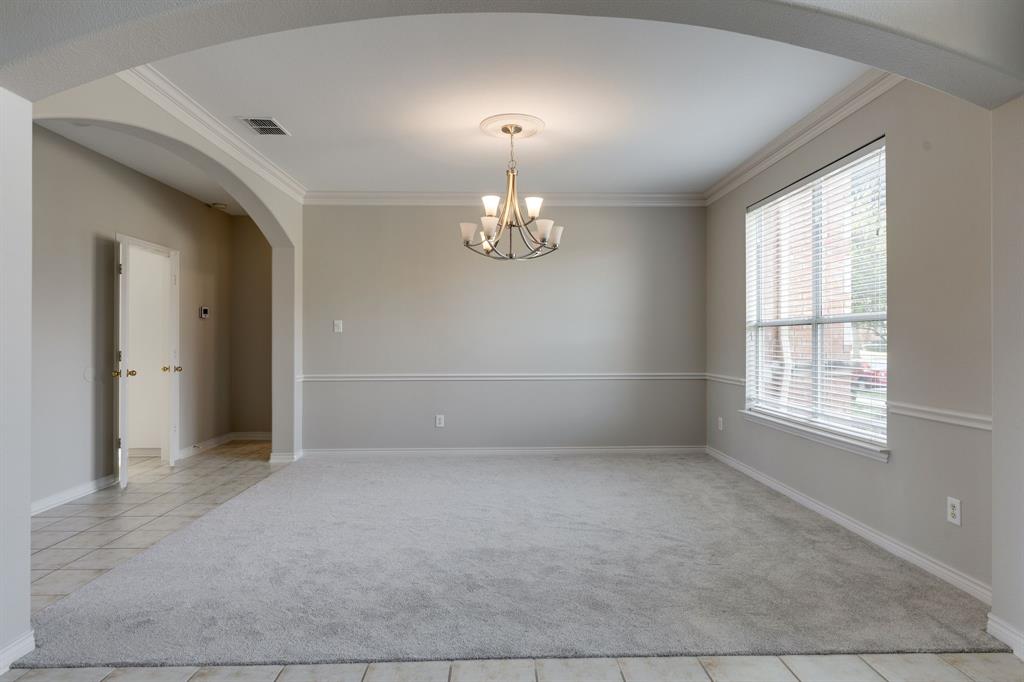 3008 Chippenham Drive Plano, TX 75093 - Photo 3 of 25 an empty room with chandelier and windows