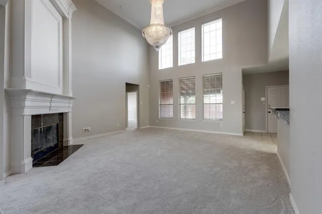 a view of an empty room with a fireplace and a window