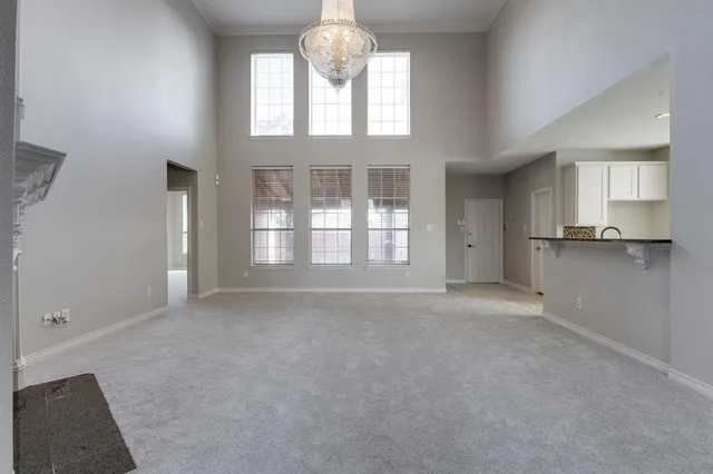 an empty room with a fireplace and windows
