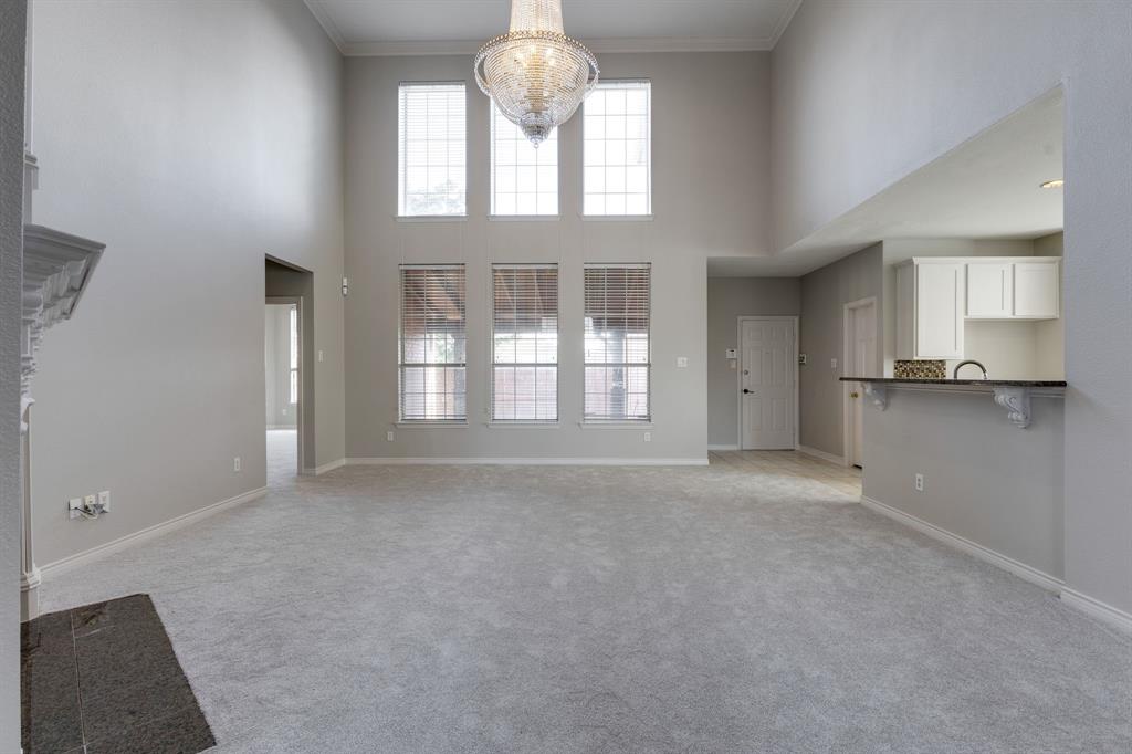 3008 Chippenham Drive Plano, TX 75093 - Photo 6 of 25 an empty room with a fireplace and windows