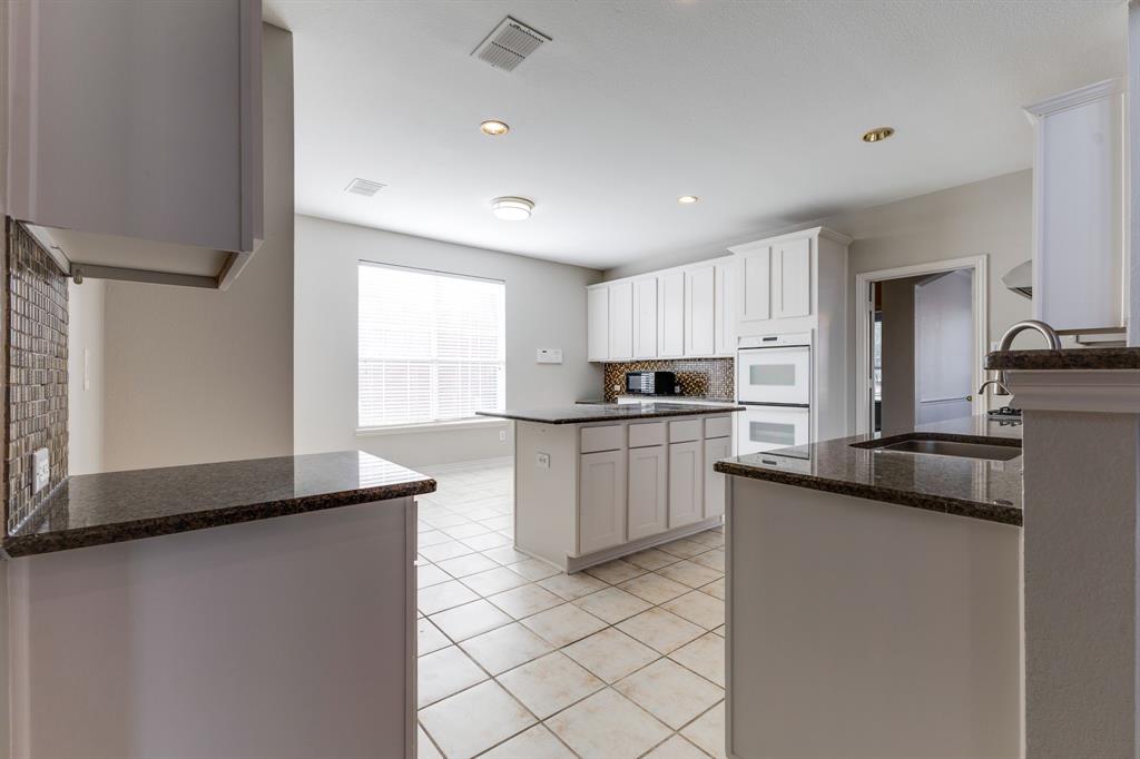 3008 Chippenham Drive Plano, TX 75093 - Photo 8 of 25 a kitchen with a sink a stove a refrigerator and cabinets