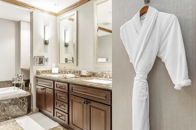 a bathroom with a sink a mirror and a bathtub