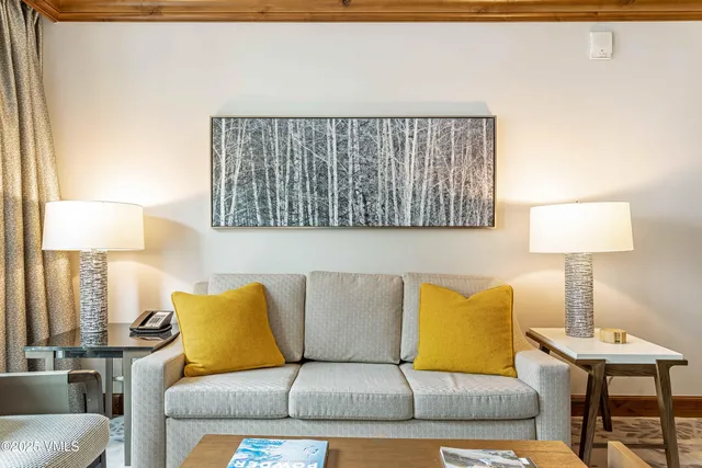 a living room with a couch and a lamp on table